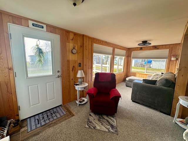 living room with carpet floors and wood walls