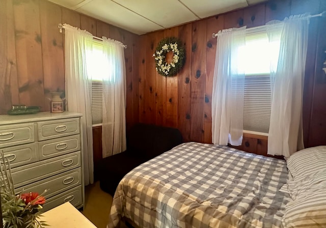 bedroom featuring wooden walls