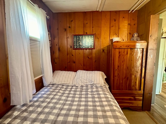 bedroom featuring wooden walls