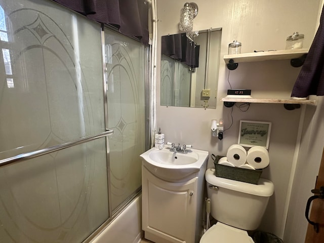 full bathroom featuring shower / bath combination with glass door, vanity, and toilet