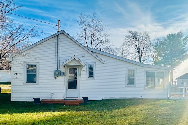 back of property with a yard