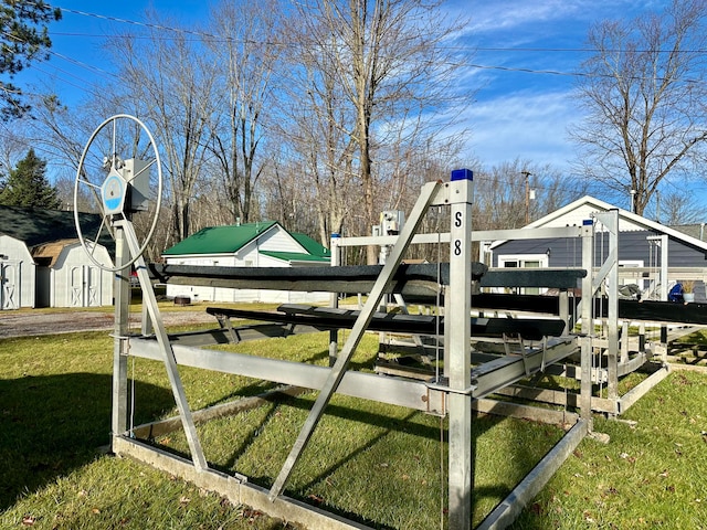 view of jungle gym featuring a yard and a storage shed