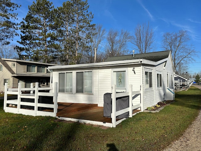 view of side of property featuring a yard and a deck