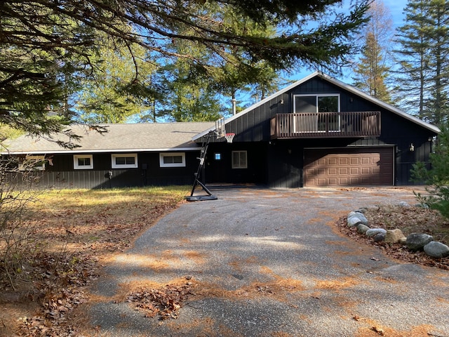 view of front of property with a garage and a balcony