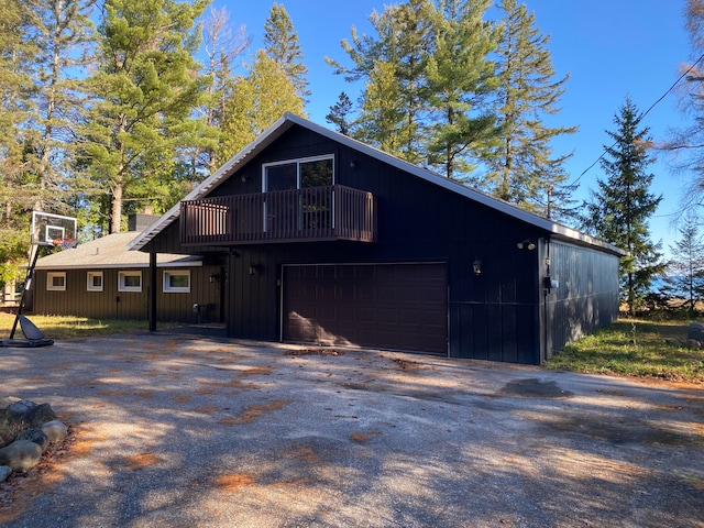 exterior space featuring a balcony and a garage