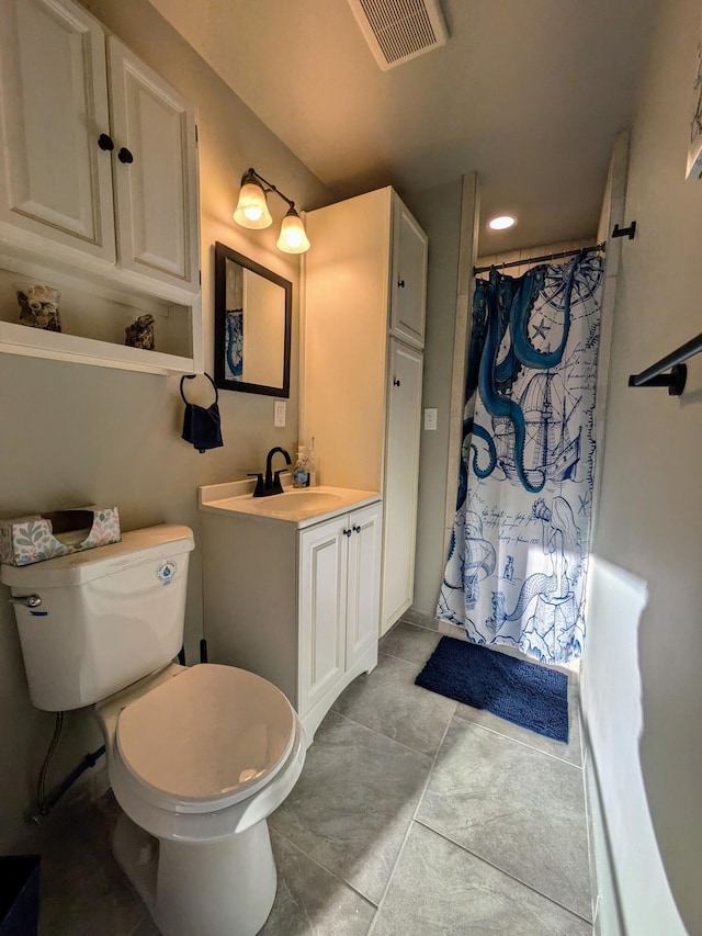 bathroom featuring tile patterned flooring, vanity, curtained shower, and toilet