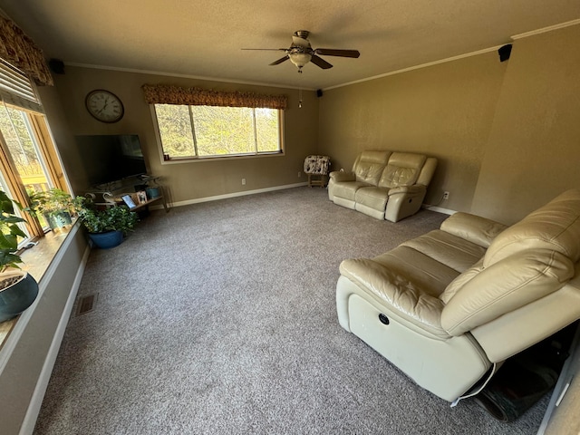 carpeted living room with a textured ceiling, ceiling fan, and crown molding