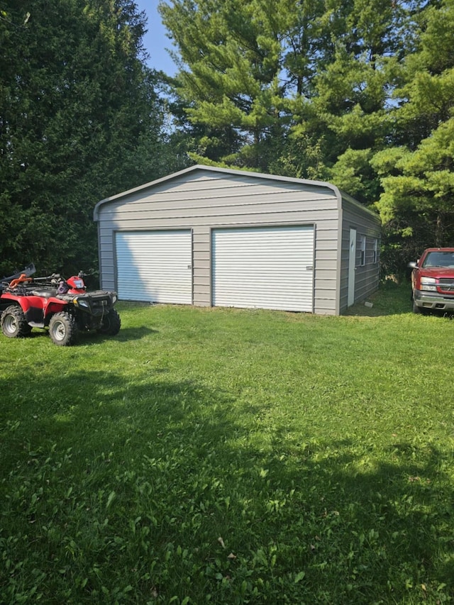 garage featuring a yard