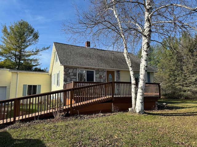 view of front of home with a front yard and a wooden deck