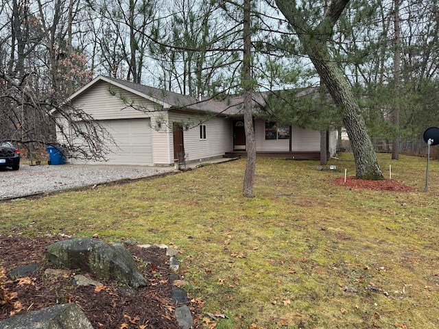 view of front of home with a garage and a front lawn