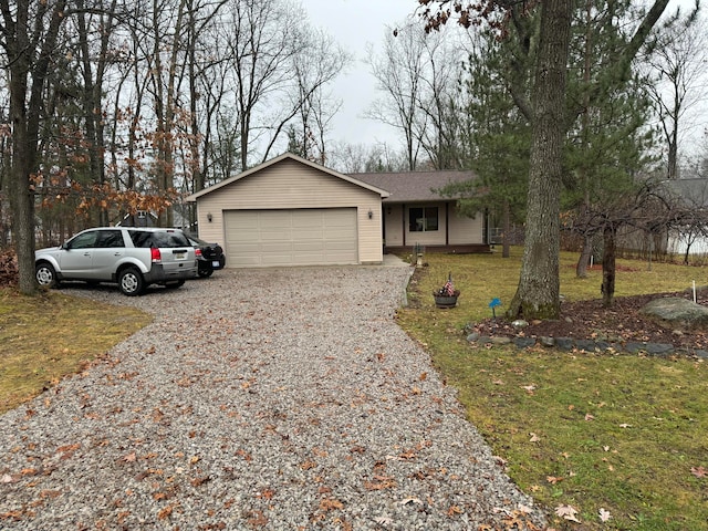 single story home featuring a front yard and a garage