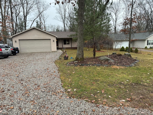 ranch-style house featuring a garage and a front yard