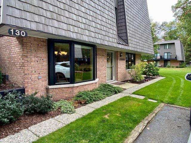 doorway to property with a lawn