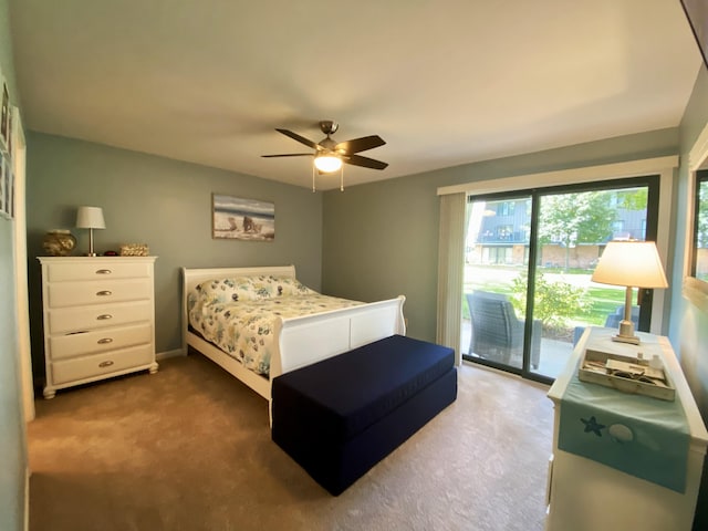 bedroom with dark colored carpet, access to outside, and ceiling fan