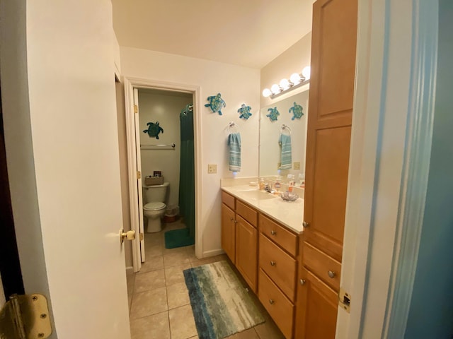 bathroom featuring tile patterned flooring, vanity, and toilet