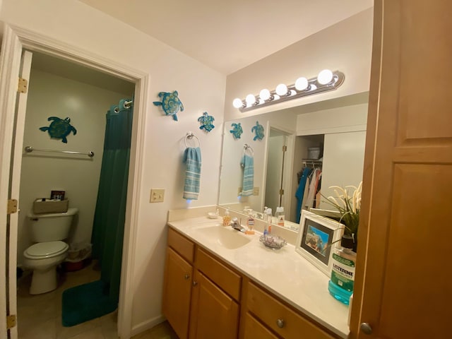 bathroom with tile patterned floors, walk in shower, vanity, and toilet