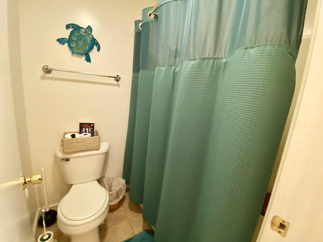 bathroom with a shower with curtain, tile patterned flooring, and toilet