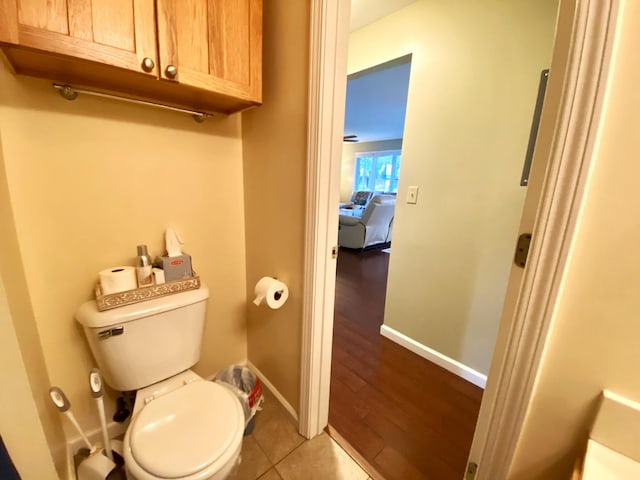 bathroom featuring wood-type flooring and toilet