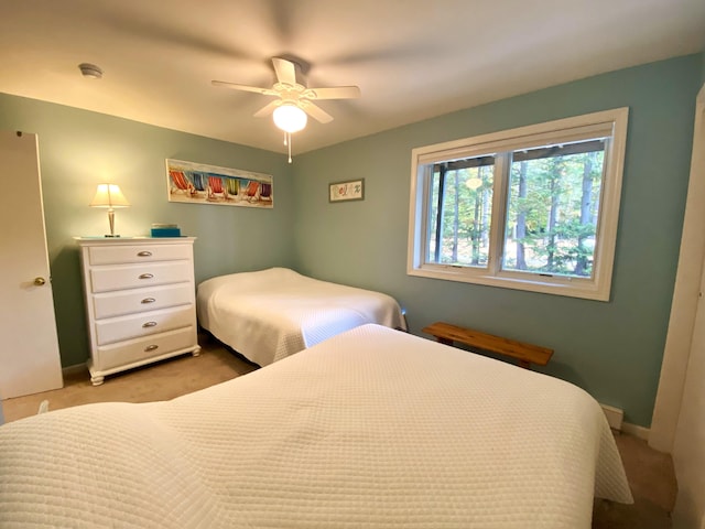 bedroom with ceiling fan and light carpet