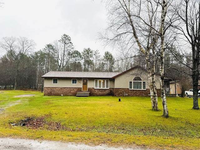 ranch-style house featuring a front lawn