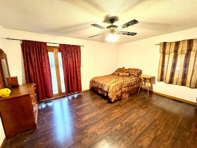 bedroom featuring a textured ceiling, ceiling fan, and dark hardwood / wood-style floors