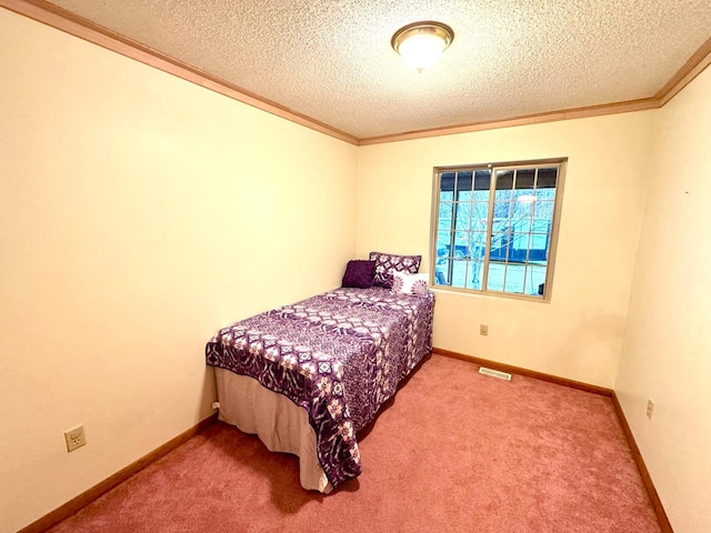 bedroom featuring carpet flooring, crown molding, and a textured ceiling