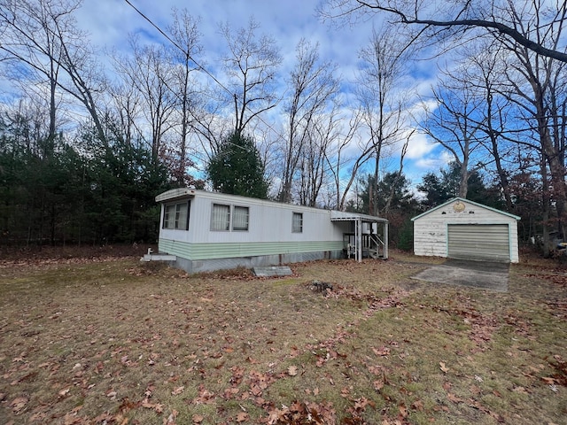 view of front of property with a front yard, an outdoor structure, and a garage