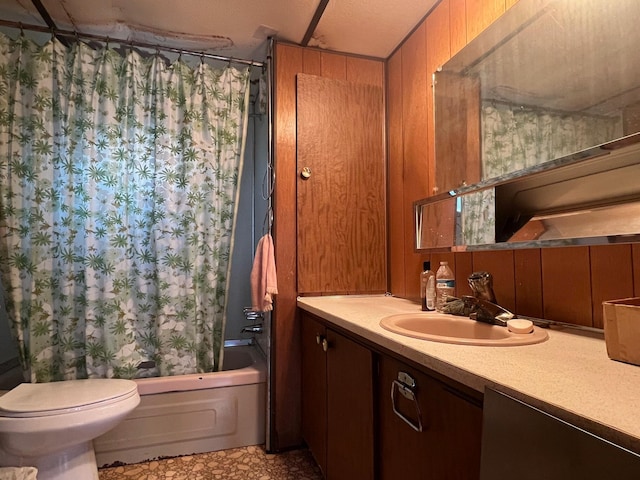 full bathroom featuring a textured ceiling, toilet, wooden walls, shower / tub combo with curtain, and vanity