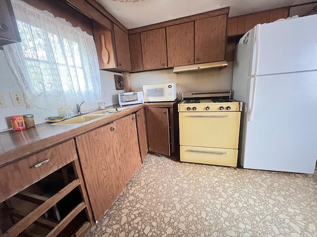 kitchen featuring white appliances and sink