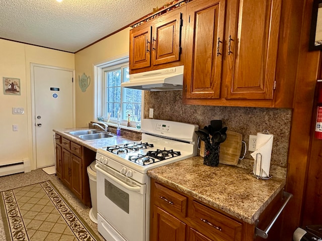 kitchen with a textured ceiling, sink, baseboard heating, and white gas range oven