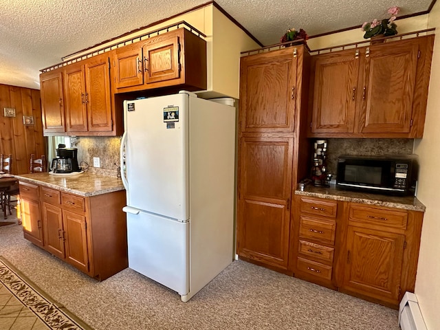 kitchen with tasteful backsplash, white fridge, a textured ceiling, and a baseboard heating unit