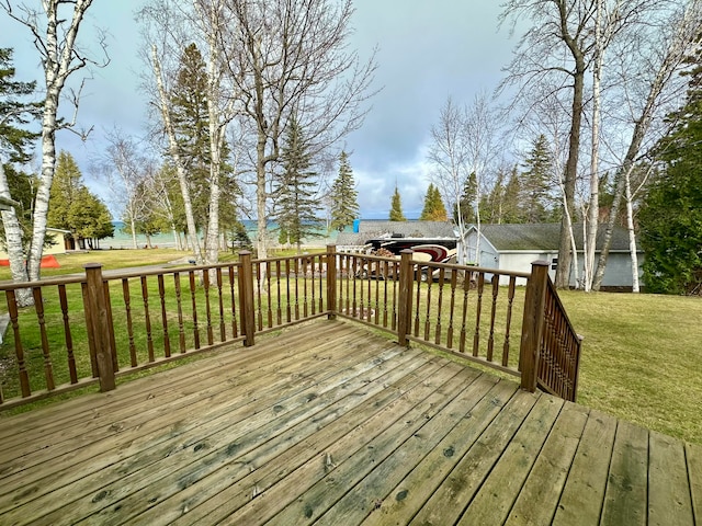 wooden terrace with a water view and a lawn