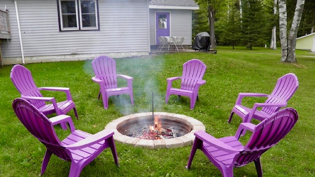 view of yard with an outdoor fire pit