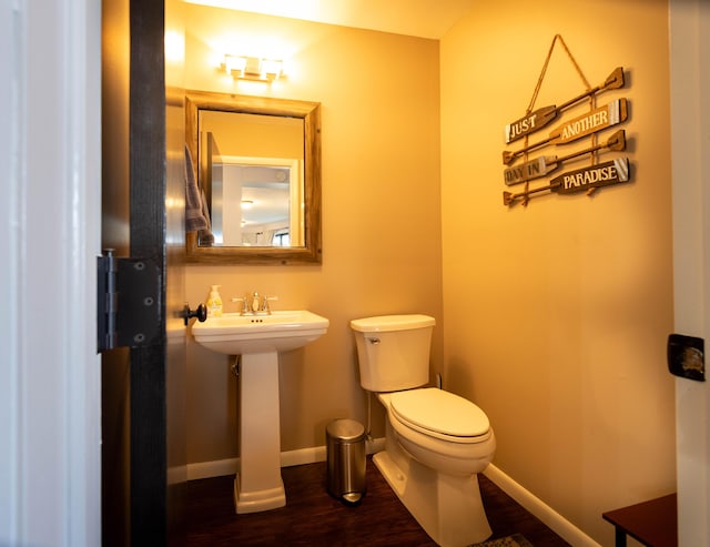 bathroom featuring hardwood / wood-style floors, toilet, and sink