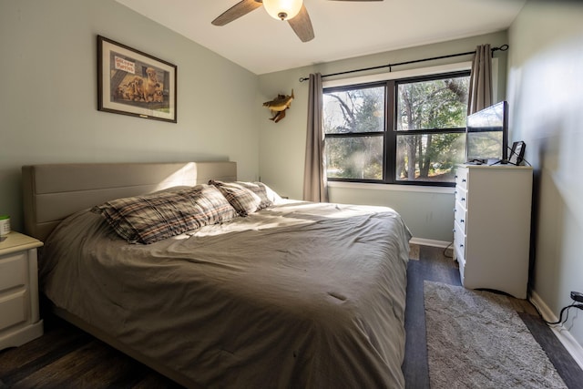 bedroom with ceiling fan and dark wood-type flooring