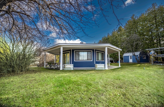 view of side of home featuring a yard, covered porch, and a shed