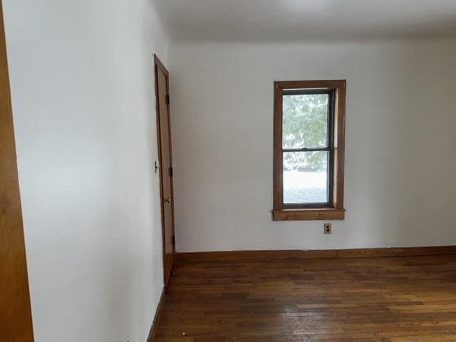 empty room featuring dark hardwood / wood-style flooring