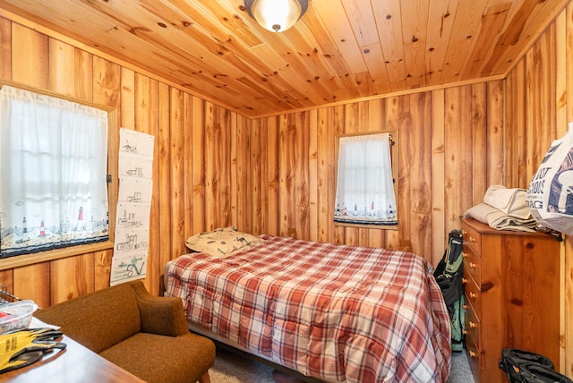 carpeted bedroom featuring wood walls and wood ceiling