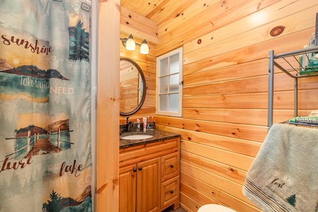 bathroom featuring wood walls, vanity, wood ceiling, and walk in shower