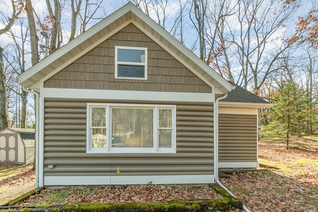 view of side of home with a storage unit