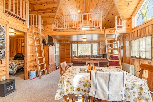 dining space featuring carpet, high vaulted ceiling, wood ceiling, and wooden walls