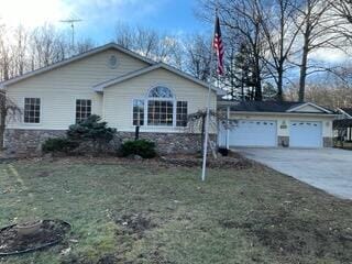 view of front of house with a front yard and a garage