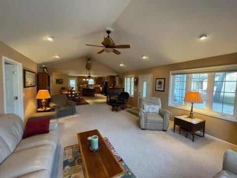 carpeted living room with ceiling fan and lofted ceiling