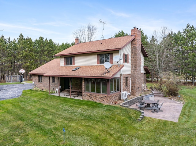 back of property with ac unit, a patio area, and a lawn