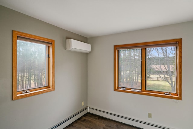 spare room featuring a baseboard radiator, a wall mounted AC, and dark hardwood / wood-style floors