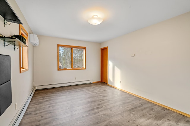 empty room featuring an AC wall unit, light hardwood / wood-style flooring, and a baseboard radiator