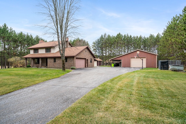 view of front of property with a front lawn and an outdoor structure