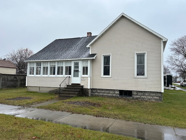 back of house featuring a lawn