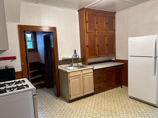 kitchen featuring sink and white appliances