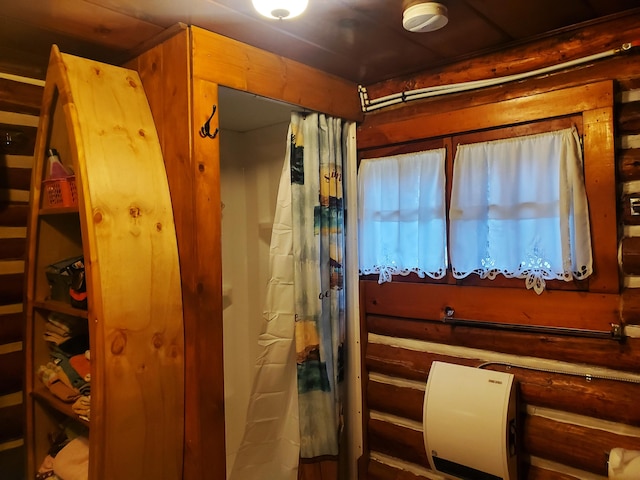 bathroom featuring wooden walls